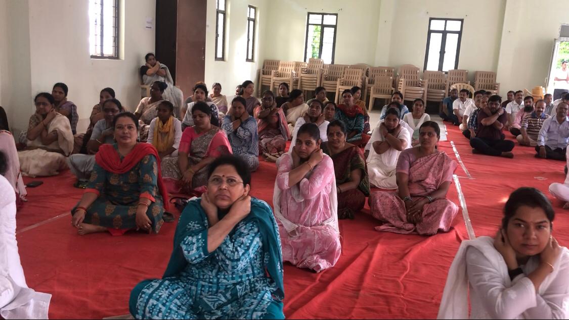 Positioning of fingers on earlobes during Workshop on Super Brain Yoga at Nizamabad Dist. Court Complex-Conference Hall on the eve of International Yoga Day i.e., on 21-06-2025.