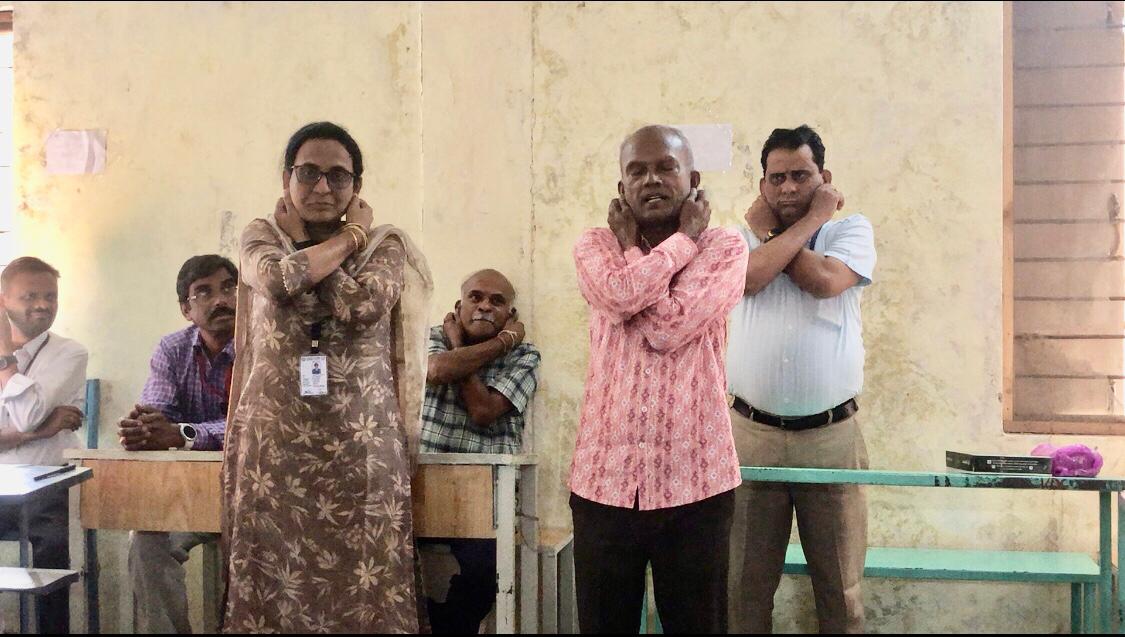 Positioning of arms on abdomen - Demonstration on Super Brain Yoga at Intermediate Spot Valuation Camp premises organized by Botany Lecturers Forum, Nizamabad & Kamareddy Districts.