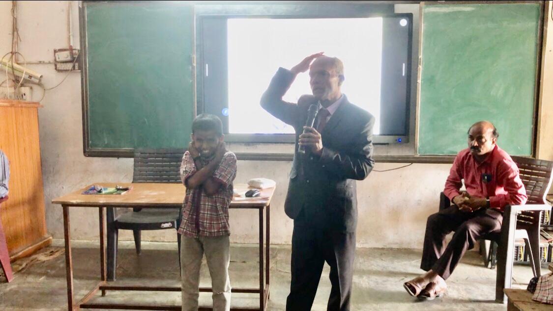 Positioning of fingers on earlobes-Workshop on Super Brain Yoga at Zilla Parishad High School, Dhupally, Renjal Mandal.