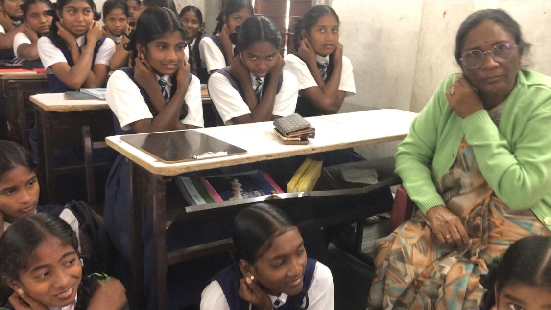 Positioning of fingers on earlobes-Workshop on Super Brain Yoga at Zilla Parishad High School, Suddulam, Dichpally Mandal.