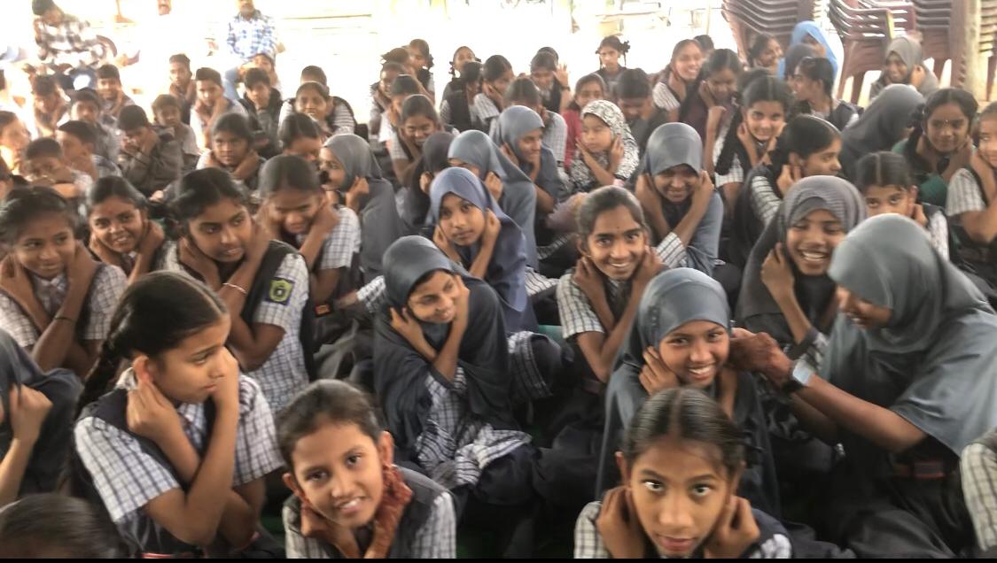 Positioning of fingers on earlobes- Workshop on Super Brain Yoga at Sri Sai Prasanna High School, Saeaswathi Nagar, Bodhan.