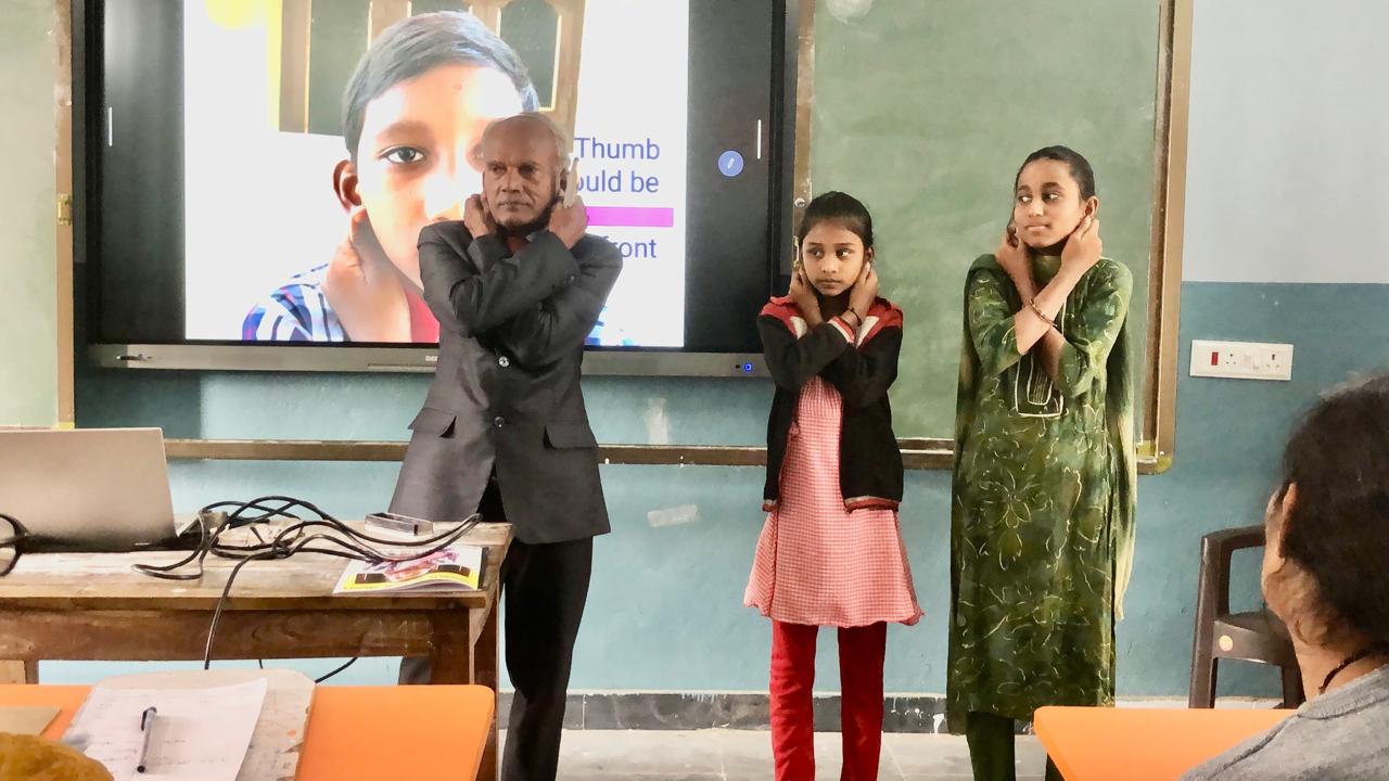 Positioning of arms on abdomen and fingers on earlobes - Workshop on Super Brain Yoga at Zilla Parishad Girls High School, Chinna Malla Reddy, Kama Reddy Dist.