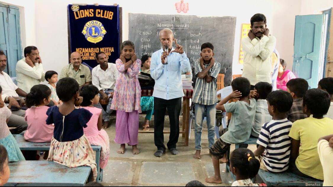 Positioning of fingers on earlobes - Workshop on Super Brain Yoga at Mandal Parishad Primary School, Dharmaram-M, Nizamabad Rural Mandal, sponsored by International Lions Club of Nizamabad-Netha.