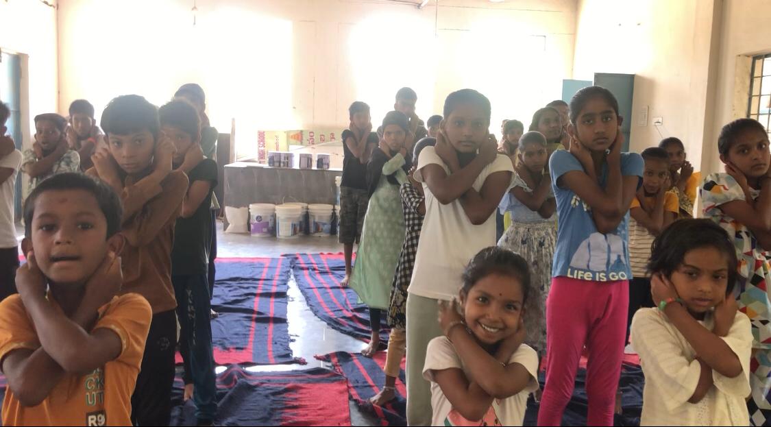 Positioning of fingers on earlobes and arms on abdomen - Workshop on  Super Brain Yoga at Summer Camp, Govt. High School, Kota Gally (Shankar Bhavan), Nizamabad on 16-05-2026.