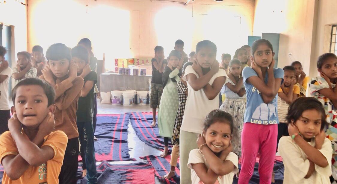 Positioning of fingers on earlobes during Super Brain Yoga at Summer Camp, PM Sri Govt. High School (JC), Rakasipet, BODHAN, sponsored by Patanhali Sukshma Dhyana Yoga Kendra, Bodhan and Patajnali Yoga Samithi, Bodhan.