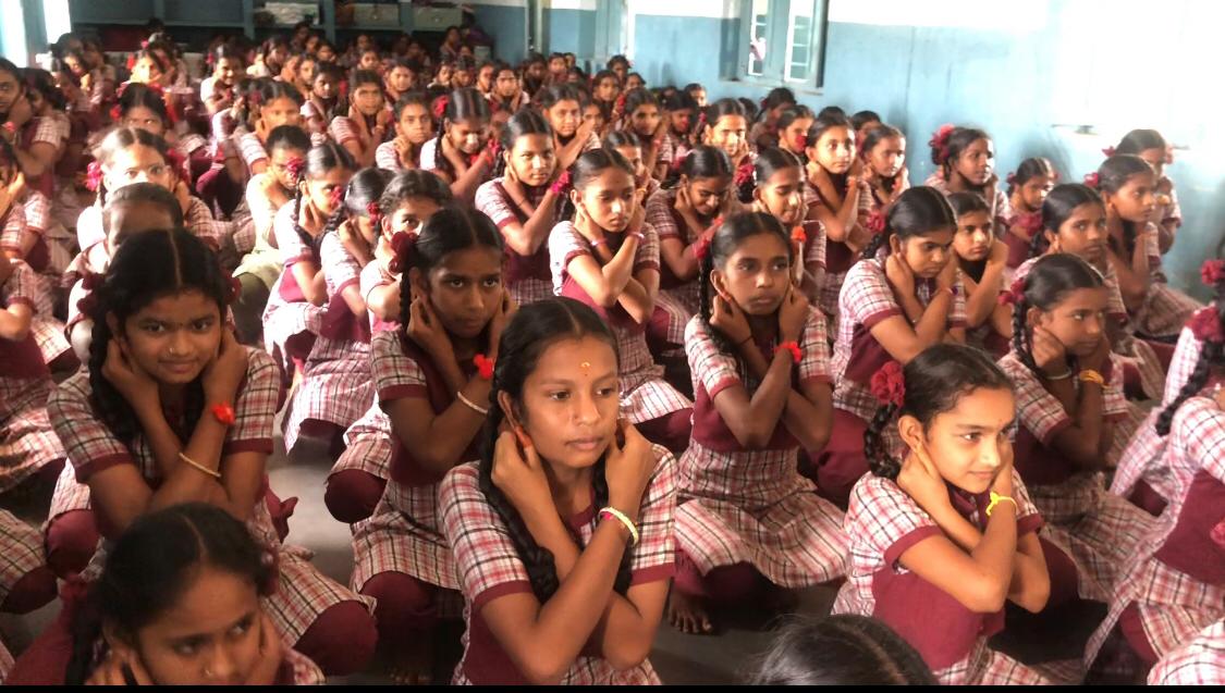 Positioning of fingers on earlobes during performing Super Brain Yoga at Kasturba Gandhi Balika Vidyalaya (KGBV), Nagireddyper, Kamareddy Dist. 