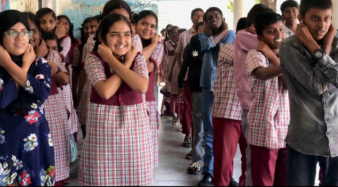 Positioning of arms on abdomen during Super Brain Yoga - Workshop on Super Brain Yoga at Zilla Parishad High School, KESAEA, Medchal - Malkajgiri Dist.