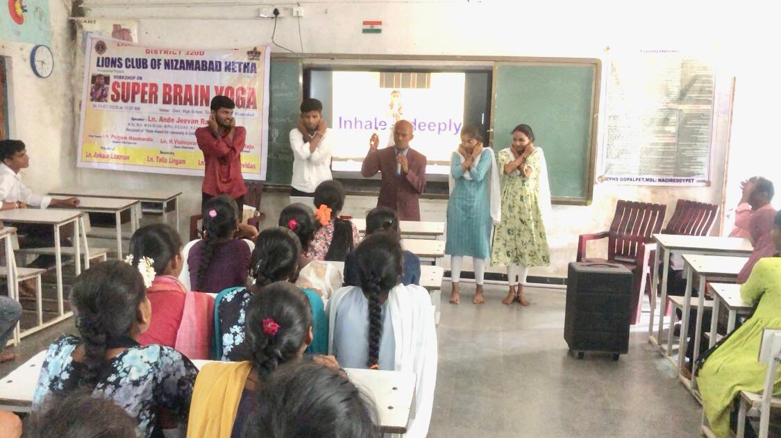 Demonstration of positioning of fingers on earlobes - Workshop on Super Brain Yoga at Govt. Junior College, Nagireddy Pet , Kamareddy Dist., sponsored by International  Lions Club of Nizamabad-Netha.
